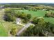 An aerial view of the home showing its secluded location surrounded by lush greenery and open fields at 190 Ccc Rd, Kingston, GA 30145
