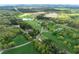 Wide aerial view showing vast land, including trees, surrounding properties, and road networks at 190 Ccc Rd, Kingston, GA 30145