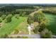 Aerial view of property showing house, trees, surrounding landscape, and road access at 190 Ccc Rd, Kingston, GA 30145