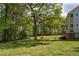 Large backyard with mature trees, grassy lawn, and a red tree swing at 190 Ccc Rd, Kingston, GA 30145