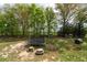 Spacious backyard with a trampoline, picnic table, and wooded boundary at 190 Ccc Rd, Kingston, GA 30145