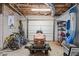 Unfinished basement with garage door, storage, lawnmower, bikes and kayak at 190 Ccc Rd, Kingston, GA 30145