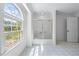 Bright bathroom with large arched window and bathtub with sliding glass doors at 190 Ccc Rd, Kingston, GA 30145