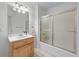 Bright bathroom features a wooden vanity, large mirror, and bathtub with sliding glass doors at 190 Ccc Rd, Kingston, GA 30145