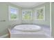 Bathroom featuring large soaking tub surrounded by tile at 190 Ccc Rd, Kingston, GA 30145