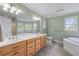 Bathroom with dual sink vanity, large mirror, garden tub, and separate shower at 190 Ccc Rd, Kingston, GA 30145