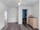 Bedroom with gray wood-look flooring, a ceiling fan, and closet with blue painted interior at 190 Ccc Rd, Kingston, GA 30145