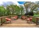Relaxing outdoor deck with orange mid-century modern style furniture overlooking a grassy yard at 190 Ccc Rd, Kingston, GA 30145