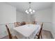 Formal dining room with chandelier and seating for six, offering a view to the adjacent kitchen at 190 Ccc Rd, Kingston, GA 30145