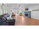 Comfortable living room showcasing a fireplace, hardwood flooring, and an open layout leading to other rooms at 190 Ccc Rd, Kingston, GA 30145