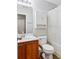 Bathroom features wood vanity, white toilet, and shower with white curtain at 230 Silver Fox Trl, Dallas, GA 30157