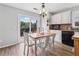 Cozy dining area featuring a wooden table with white chairs, stainless steel appliances, and sliding door at 230 Silver Fox Trl, Dallas, GA 30157