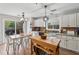 Open kitchen and breakfast nook with backyard views and wood island at 230 Silver Fox Trl, Dallas, GA 30157