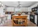 Charming kitchen featuring a wood island, white cabinets, and modern appliances at 230 Silver Fox Trl, Dallas, GA 30157