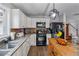 Charming kitchen features white cabinets, granite counters, and stainless appliances at 230 Silver Fox Trl, Dallas, GA 30157