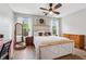 Bright main bedroom with a fan, windows, and wood-look flooring at 230 Silver Fox Trl, Dallas, GA 30157