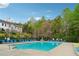 Community pool with plenty of chairs and lush surrounding trees at 230 Silver Fox Trl, Dallas, GA 30157