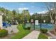 Tennis courts surrounded by lush trees on a sunny day at 230 Silver Fox Trl, Dallas, GA 30157