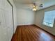 Bedroom featuring hardwood floors, closet and window with ceiling fan at 3150 Berkshire Manor Dr, Alpharetta, GA 30022