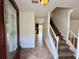 Bright foyer featuring a staircase, tile flooring, and a decorative glass front door at 3150 Berkshire Manor Dr, Alpharetta, GA 30022