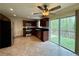 Updated kitchen with stainless steel appliances, dark cabinets, tile flooring, and a sliding glass door at 3150 Berkshire Manor Dr, Alpharetta, GA 30022