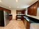 Updated kitchen with stainless steel appliances, dark cabinets, and tile flooring at 3150 Berkshire Manor Dr, Alpharetta, GA 30022