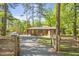 Quaint brick home with a bright yellow front door, complemented by a well-maintained lawn and lush greenery at 3385 Pinehill Dr, Decatur, GA 30032