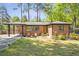 Well-kept brick home with a covered entrance, manicured lawn, and inviting front yard seating area at 3385 Pinehill Dr, Decatur, GA 30032