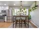 Modern kitchen with stainless steel appliances, white cabinets, and a stylish dining area with bar stools at 3385 Pinehill Dr, Decatur, GA 30032