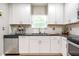 Modern kitchen features white cabinets, stainless steel appliances, and granite countertops at 3385 Pinehill Dr, Decatur, GA 30032