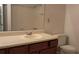 Neutral bathroom featuring a white sink, wood cabinet, and a shower-tub combo with white tile surround at 340 Teal Ct, Roswell, GA 30076