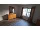 Bright bedroom featuring neutral walls, wood-look floors, and ample natural light at 340 Teal Ct, Roswell, GA 30076