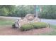 Stone community entrance sign surrounded by manicured bushes and well maintained landscaping at 340 Teal Ct, Roswell, GA 30076