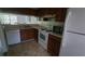 Efficient kitchen with wooden cabinets, white appliances, and a view to the dining area at 340 Teal Ct, Roswell, GA 30076