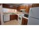 Functional kitchen featuring essential appliances and wooden cabinets at 340 Teal Ct, Roswell, GA 30076