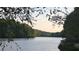 Scenic lake view with surrounding greenery and mature trees, creating a tranquil and picturesque setting at 340 Teal Ct, Roswell, GA 30076