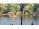 Beautiful lake view with a small island, surrounded by trees at 340 Teal Ct, Roswell, GA 30076
