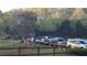 Tennis courts with parked cars and lush trees in the background at 340 Teal Ct, Roswell, GA 30076