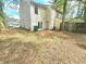 Backyard of a two-story home with a small patio area and a fenced yard, providing privacy at 1557 Springleaf Se Ct, Smyrna, GA 30080