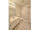 Bathroom with a marble-look tile shower, modern faucet, and new toilet at 1557 Springleaf Se Ct, Smyrna, GA 30080
