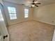 Spacious bedroom with neutral carpet, ceiling fan, and two windows for lots of natural light at 1557 Springleaf Se Ct, Smyrna, GA 30080