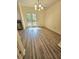 Dining room with wood floors and a chandelier, next to french doors at 1557 Springleaf Se Ct, Smyrna, GA 30080