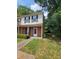 Charming townhome featuring brick facade, manicured lawn, and inviting front entrance at 1557 Springleaf Se Ct, Smyrna, GA 30080