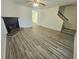 This living room features a fireplace, a ceiling fan, and nearby stairs at 1557 Springleaf Se Ct, Smyrna, GA 30080