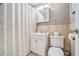Cozy bathroom featuring a vanity sink with storage, toilet, mirror, and shower at 215 Piedmont Ne Ave # 2003, Atlanta, GA 30308