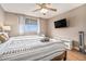 Cozy bedroom with natural light, comfortable bed, ceiling fan, and mounted TV at 215 Piedmont Ne Ave # 2003, Atlanta, GA 30308