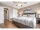 Comfortable bedroom with natural light, ceiling fan, and a view into the hall at 215 Piedmont Ne Ave # 2003, Atlanta, GA 30308