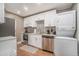 Modern kitchen featuring white cabinetry, stainless steel appliances, and a convenient washer/dryer combo at 215 Piedmont Ne Ave # 2003, Atlanta, GA 30308