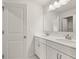 Bathroom with double sinks, a large mirror, white cabinets, and a decorative light fixture at 3740 Near Star Ln, Cumming, GA 30028
