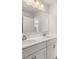Spacious bathroom featuring double sinks, white cabinets, and a decorative light fixture at 3740 Near Star Ln, Cumming, GA 30028